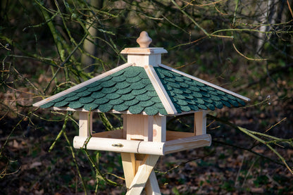 Handgefertigtes Vogelhaus mit grünem Bitumendach, schützt Vogelfutter vor Regen, ideal für einheimische Vögel.